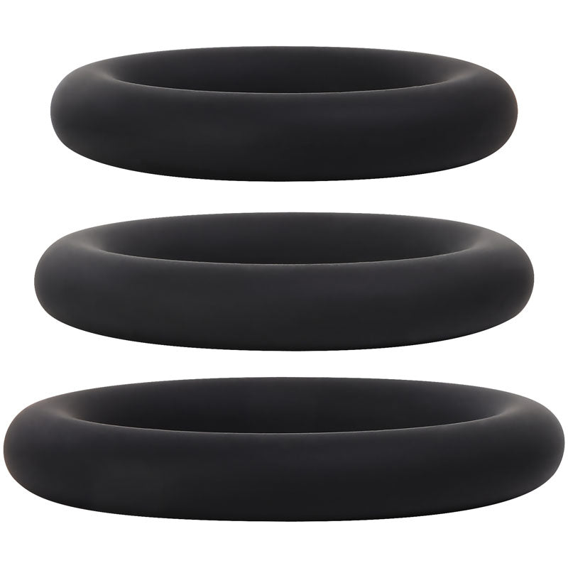 The Adam & Eve Silicone Penis Ring Set, featuring three black rings in different sizes, is displayed vertically on a white background. They have a soft, smooth matte finish and minimalist design, ideal for prolonging erections.