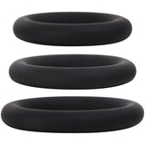 The Adam & Eve Silicone Penis Ring Set features three smooth, matte black cock rings stacked vertically against a white background. Designed for erection enhancement, they are identical in shape but vary in size.