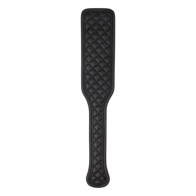 The Adam & Eve Fetish Dreams Beginner Bondage Set includes a black vegan leather paddle with quilted diamond stitching, a narrower handle, and a broad rectangular striking area with rounded edges. Its smooth, polished texture and firm yet flexible design make it ideal for erotic restraint play.