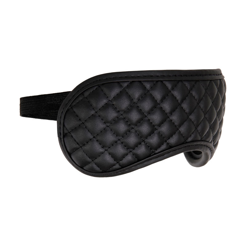 Quilt-textured, padded black eye mask made from supple vegan leather with an elastic strap, ideal for bondage sets. Part of the Adam & Eve Fetish Dreams Beginner Bondage Set - 4 Piece Kit.