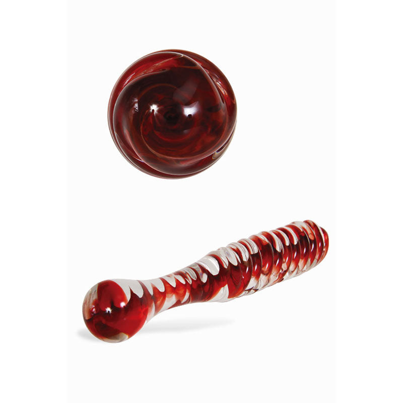 The Adam & Eve Sweetheart Swirl Glass Dildo, a 22 cm clear and red borosilicate glass piece, lies horizontally with an intricate spiral design. Its circular component mirrors the pattern with deep red and white hues, set elegantly against a plain white background.