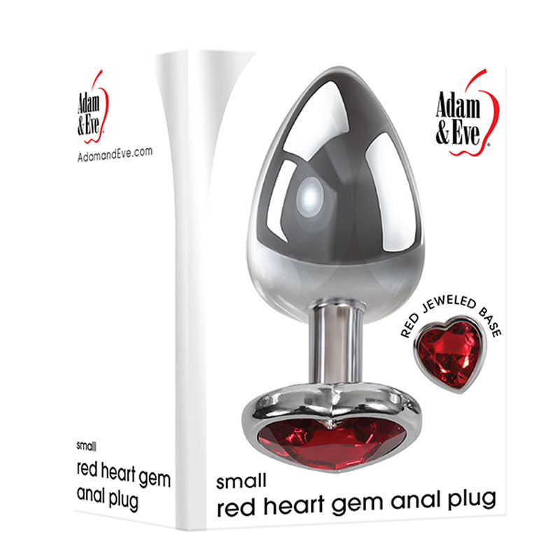 The Adam & Eve packaging features a small metallic anal plug with a silver finish and a red heart-shaped gem at the base, branded with the Adam & Eve logo and product name: Adam & Eve Red Heart Gem Anal Plug - Small. The website AdamandEve.com is also displayed.