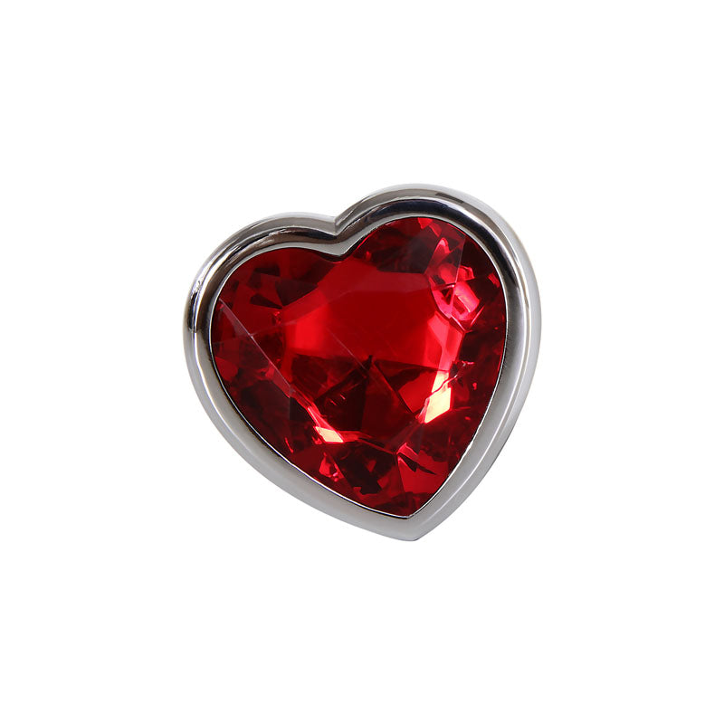 The Adam & Eve Red Heart Gem Anal Plug features a heart-shaped, faceted red gemstone set in a metallic silver frame with a jeweled base. The deep crimson hues create a sparkling effect, while the smooth, polished silver outlines enhance its shape.