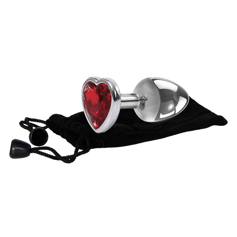 The Adam & Eve Red Heart Gem Anal Plug - Small features a metallic silver finish with a red heart gem base. It comes in a black drawstring pouch with black beads, highlighting the plugs shiny appearance and the deep red hue of its gem.