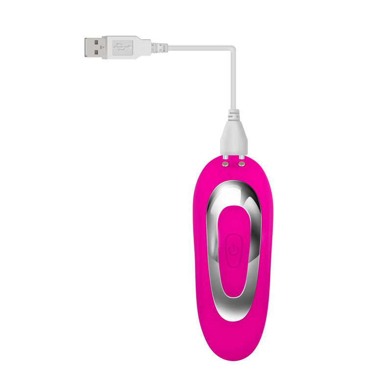 The Adam & Eve Rechargeable Dual Entry Vibe is a pink USB rechargeable vibrator with a remote control, featuring an elongated, rounded shape. It has a power button on top and connects via a white cable to a standard USB-A plug.