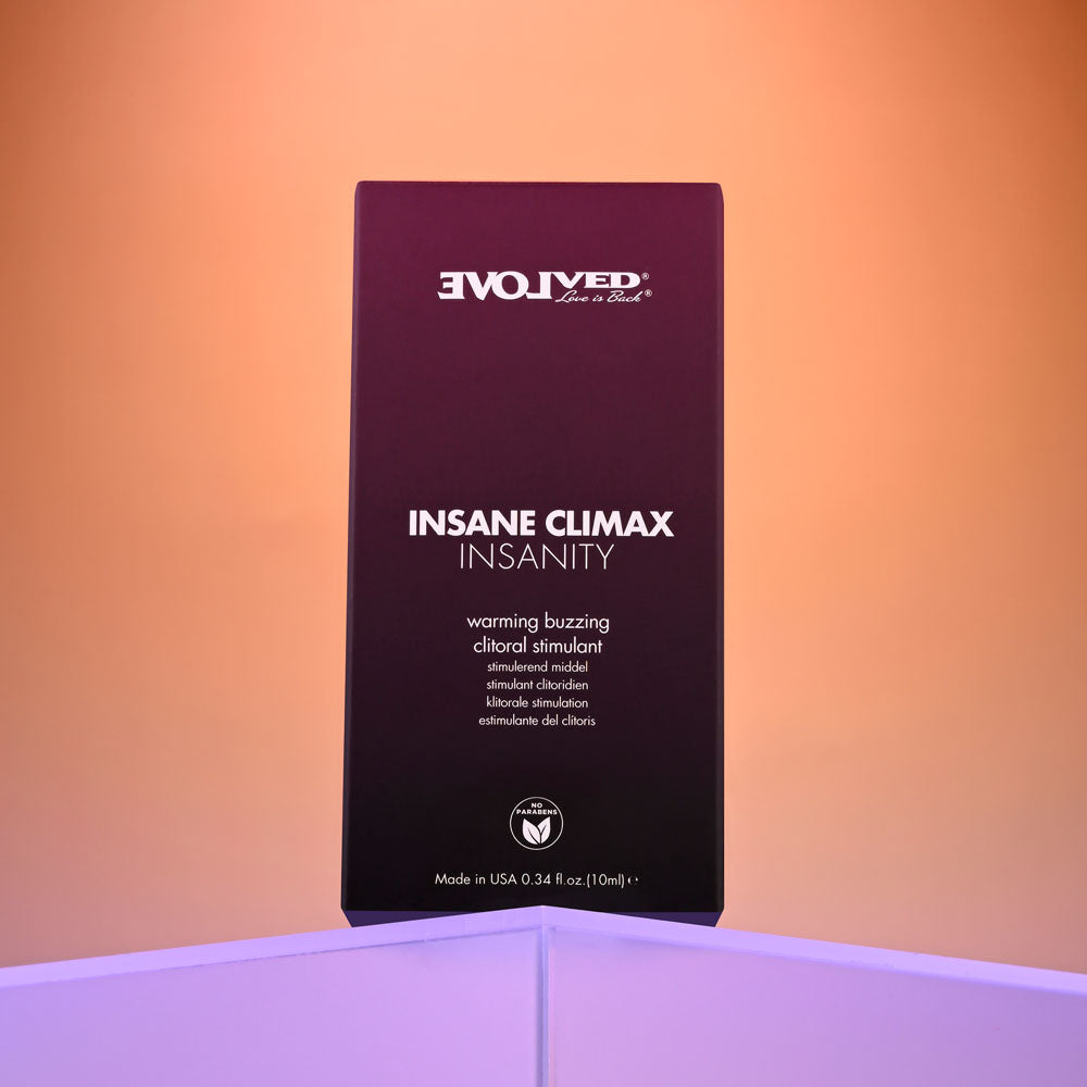 In front of a pink-orange gradient, a dark purple box with white text promotes Evolved Insane Climax Insanity, a US-made warming and buzzing clitoral stimulant. It delivers intense tingles with 0.34 fl oz (10 ml) of excitement.