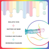 A vibrant image of the Jellido 18cm Dildo showcases its translucent, multicolored design with realistic veins and a strong suction cup. Described as flexible and pliable for incredible pleasure, its set against a dripping rainbow pattern framed by a gradient rainbow border.