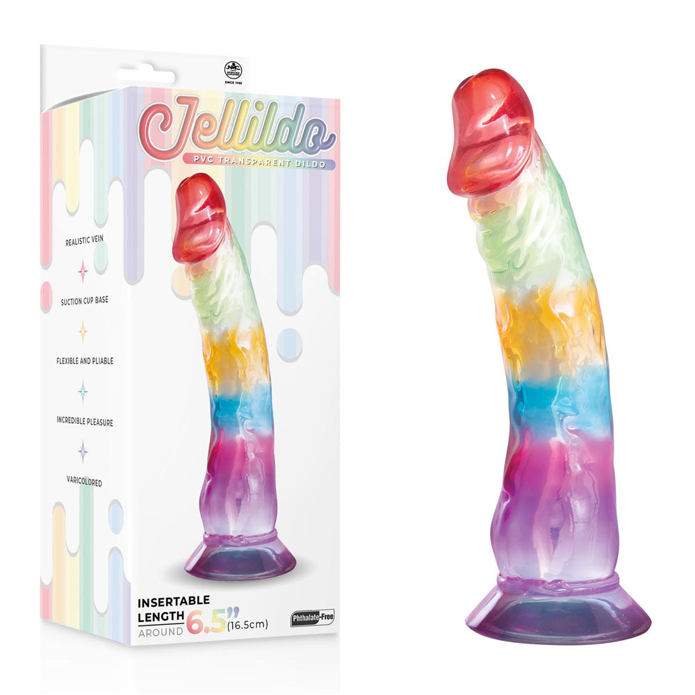 A rainbow-patterned translucent device with a realistic veined design stands upright, featuring a strong suction cup. The packaging reads Jellido 16.5cm Dildo, showcasing its flexible material and 6.5-inch insertable length.