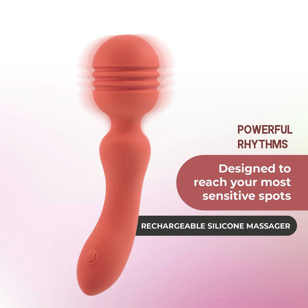 An orange silicone Xciter personal massager with a textured, bulbous head is displayed against a soft pink gradient background, featuring vibrating rhythms, an ergonomic handle, and a power button at the base. Text reads Powerful Rhythms and USB-C rechargeable for lasting pleasure.