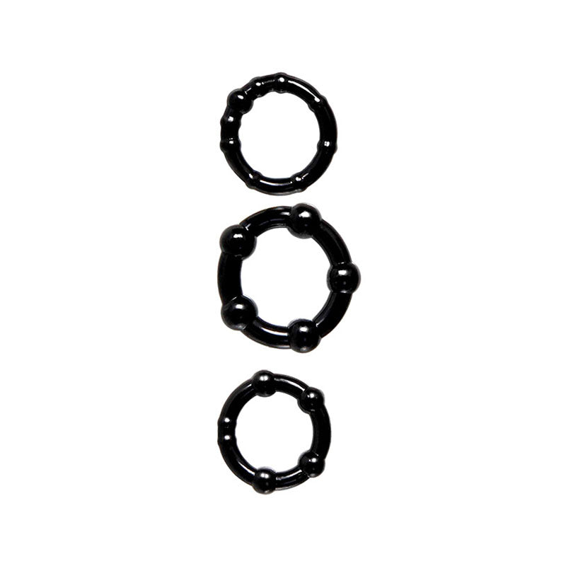 The Adam & Eve ADAMS PLEASURE KIT includes three vertically arranged black rings featuring a bumpy texture with raised circular sections, set against a white background, for a distinctive and tactile appearance.