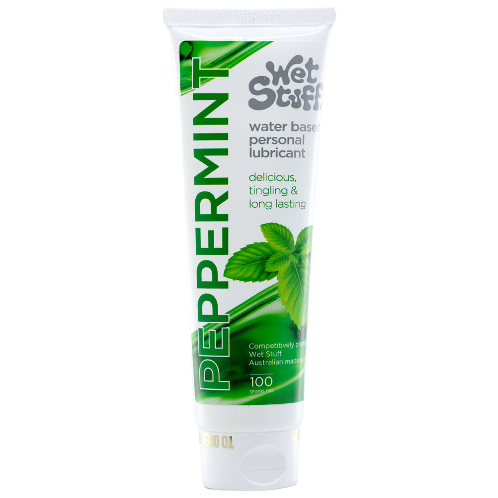 A 100g tube of Wet Stuff Peppermint water-based lubricant is hypoallergenic, edible, and Australian-made, featuring a white design with green leaves and delicious, tingling & long-lasting text.