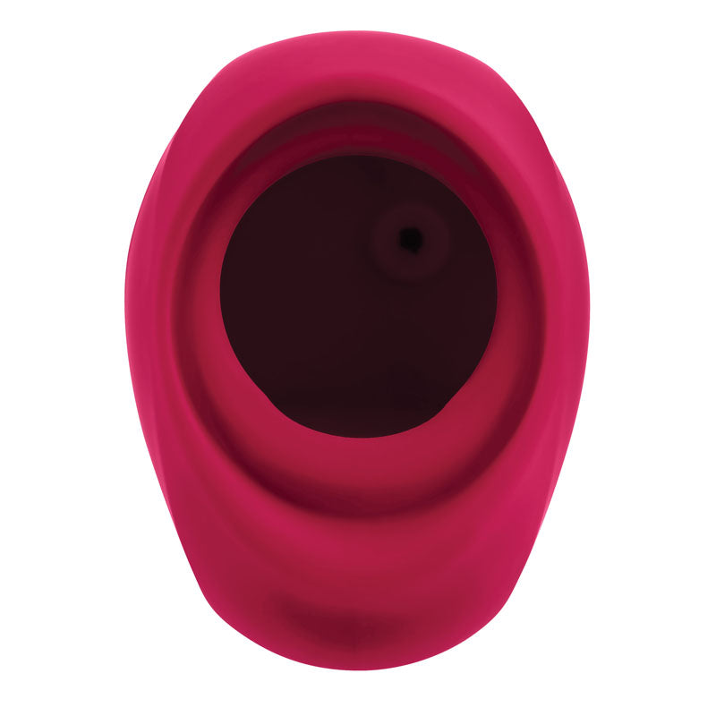 The Gender X BODY KISSES is a red, oval-shaped, USB rechargeable silicone sucking stimulator with a wide hollow interior and small circular hole in the middle. Its smooth, vibrant surface and above perspective highlight its entire opening for an optimal experience.