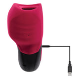 The Gender X BODY KISSES is a black and red textured silicone vibrating massager with a USB charging cable, featuring a small opening on the red top section and a button on the black bottom. The attached USB extends to the right with a standard connector.