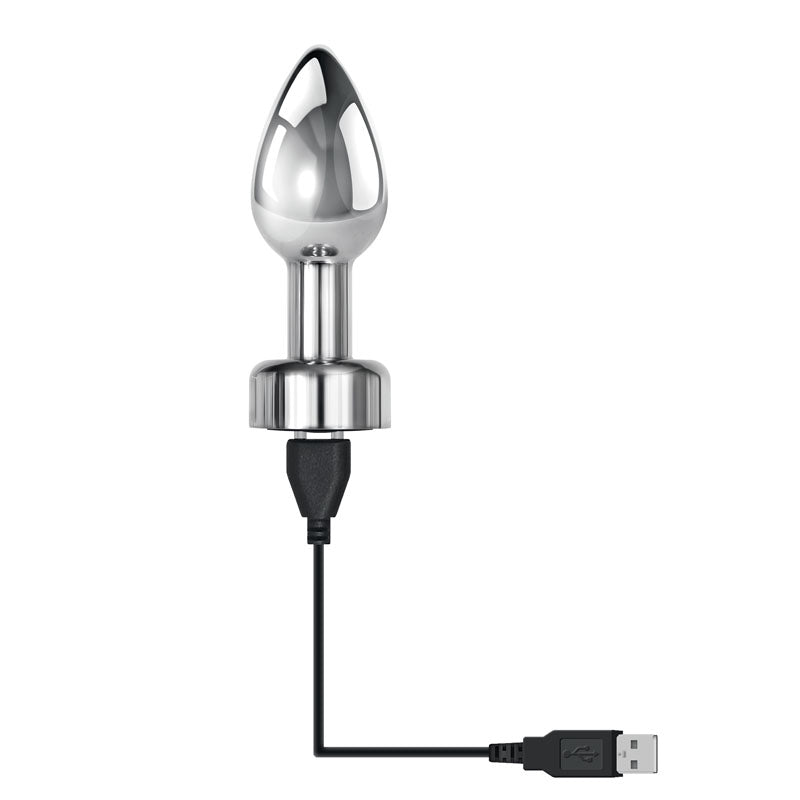 The Gender X ROCKIN METAL PLUG is a sleek, 9.3 cm metallic USB rechargeable anal plug with a smooth conical design and a flat circular base, hinting at its vibrating features. The steel-like material beautifully reflects light, adding allure to your experience.