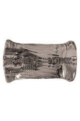 The Adam & Eve Adams 3-Way Stroker is a clear, textured cylindrical object with intricate wave-like patterns that shimmer in light. Its easy-grip exterior and slightly flared ends resemble a decorative piece, blending functionality with elegance.