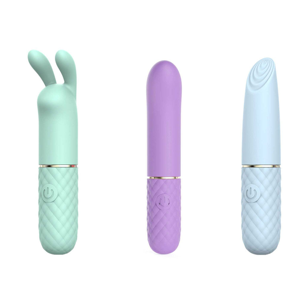 The Adam & Eve TRIPLE PLEASURES set features three USB rechargeable vibrators: a mint green with bunny ears, a smooth lavender cylinder, and a light blue vibrator with a ridged tip. Each has a quilted grip and power button at the base.