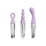 The Adam & Eve SWEET DREAMS MASSAGER KIT includes three transparent glass dildos with light purple silicone handles: a circular star-shaped handle, a beaded shaft, and a curved G-Spot/P-Spot attachment; all offer modern design with clear, textured bases.