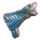 The Alien Nation - Gila - Blue/Gold 14 cm Penis Sheath is a textured, silicone sculpture of a snake with an open mouth and coiled, ribbed body, in blue, silver, and copper hues. Detailed scales and ridges create an intricate, lifelike appearance.