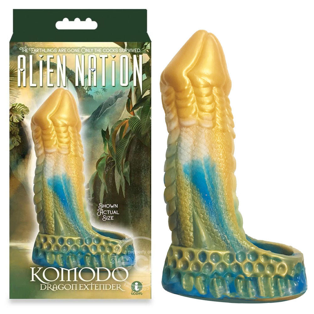 The Alien Nation box features a Komodo dragon-inspired penis extender in vibrant blue and gold. The Komodo Dragoti Extedier is prominently displayed, with the dildo’s reptilian-textured surface offering an otherworldly experience.