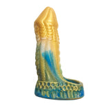 The Alien Nation - Komodo Blue/Gold Penis Extender Fantasy Sleeve is a colorful sculpted object with textured scales and fins. It features a gold and blue gradient with intricate ridges, embodying an abstract design blending AlienNation fantasy with marine life.