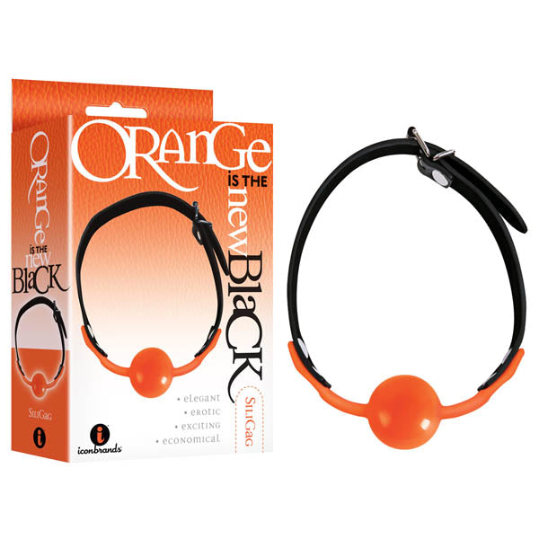 The image shows the Orange Is The New Black - Siligag, featuring a striking orange silicone ball gag with a black adjustable strap alongside its packaging, which highlights qualities such as elegant, erotic, and exciting. Both the gag and box display matching orange and black colors.