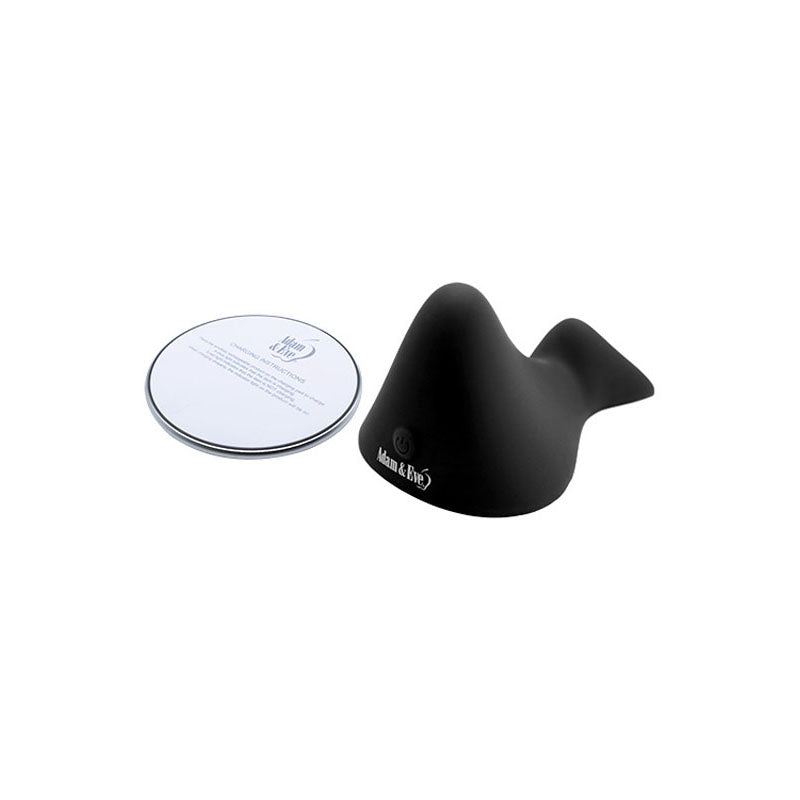 A small black, whale-shaped Adam & Eve THE RUMBLING RIDER vibrating grinder pad with a rounded base and fin is paired with a round, shiny coaster. Both have smooth surfaces; the black object displays Adam & Eve in white, while the coaster has similar branding.