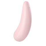 The Satisfyer Curvy 2+ is a pastel pink, curved clitoral stimulator with Air Pulse technology and two metallic buttons. Its minimalistic banana shape includes a sleek, smooth texture, slightly tapered end, and rounded base.