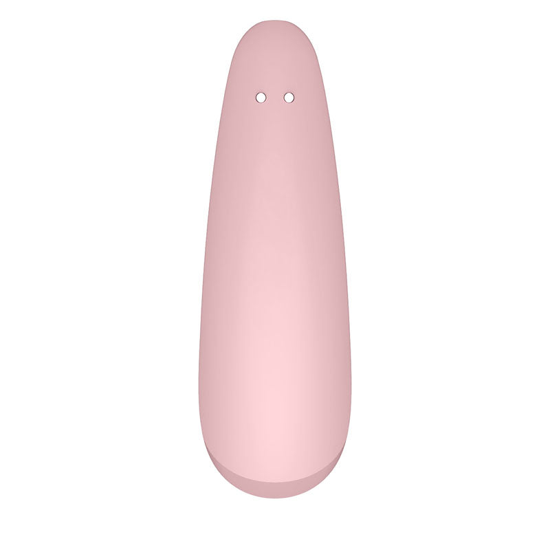 The Satisfyer Curvy 2+ is a pink silicone clitoral stimulator with a smooth, elongated oval shape and two small holes. Its matte surface adds softness, while the darker bottom enhances its design. Compatible with the Satisfyer Connect App, it offers an app-controlled, touch-free experience.