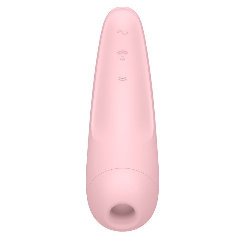 The Satisfyer Curvy 2+ is a pink, elongated, ergonomic clitoral stimulator featuring a smooth matte finish, a rounded tip, and hollow opening. It offers three tactile buttons with wave symbols for adjustable settings and is compatible with the Satisfyer Connect App for touch-free USB-rechargeable use.