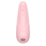 The Satisfyer Curvy 2+ is a pink, elongated, ergonomic clitoral stimulator featuring a smooth matte finish, a rounded tip, and hollow opening. It offers three tactile buttons with wave symbols for adjustable settings and is compatible with the Satisfyer Connect App for touch-free USB-rechargeable use.