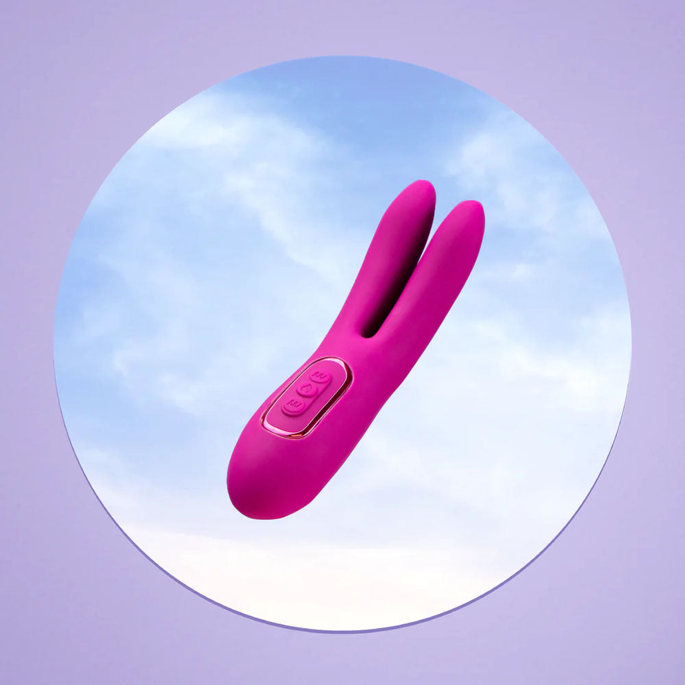 The JimmyJane Solis Ascend 2 PRO, a purple 16 cm dual-tip stimulator with dual vibrating motors and a flexible design, is centered against a circular cloudy sky cutout. It appears to float in the circle on a light purple backdrop.