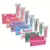 Numerous Booty Call strawberry-flavored anal numbing gel tubes are displayed. The packaging showcases pink, blue, and white hues with unique dessert-themed designs and flavor indicators. Ideal for anal play, the neatly arranged products display prominent branding.