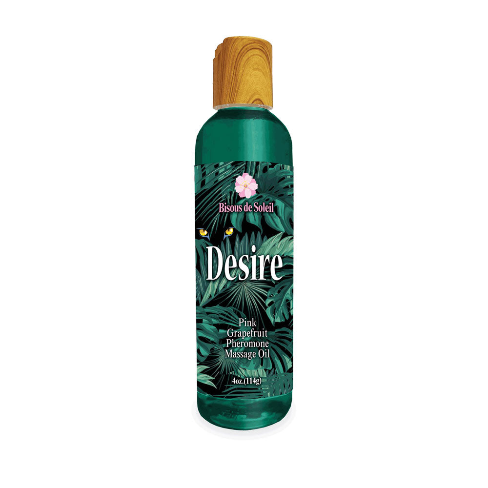 The Desire green bottle contains pink grapefruit scented pheromone massage oil, adorned with tropical leaves and colorful birds. It features a wooden-like cap and the text Bisous de Soleil along with 4oz (118mL) at the bottom.