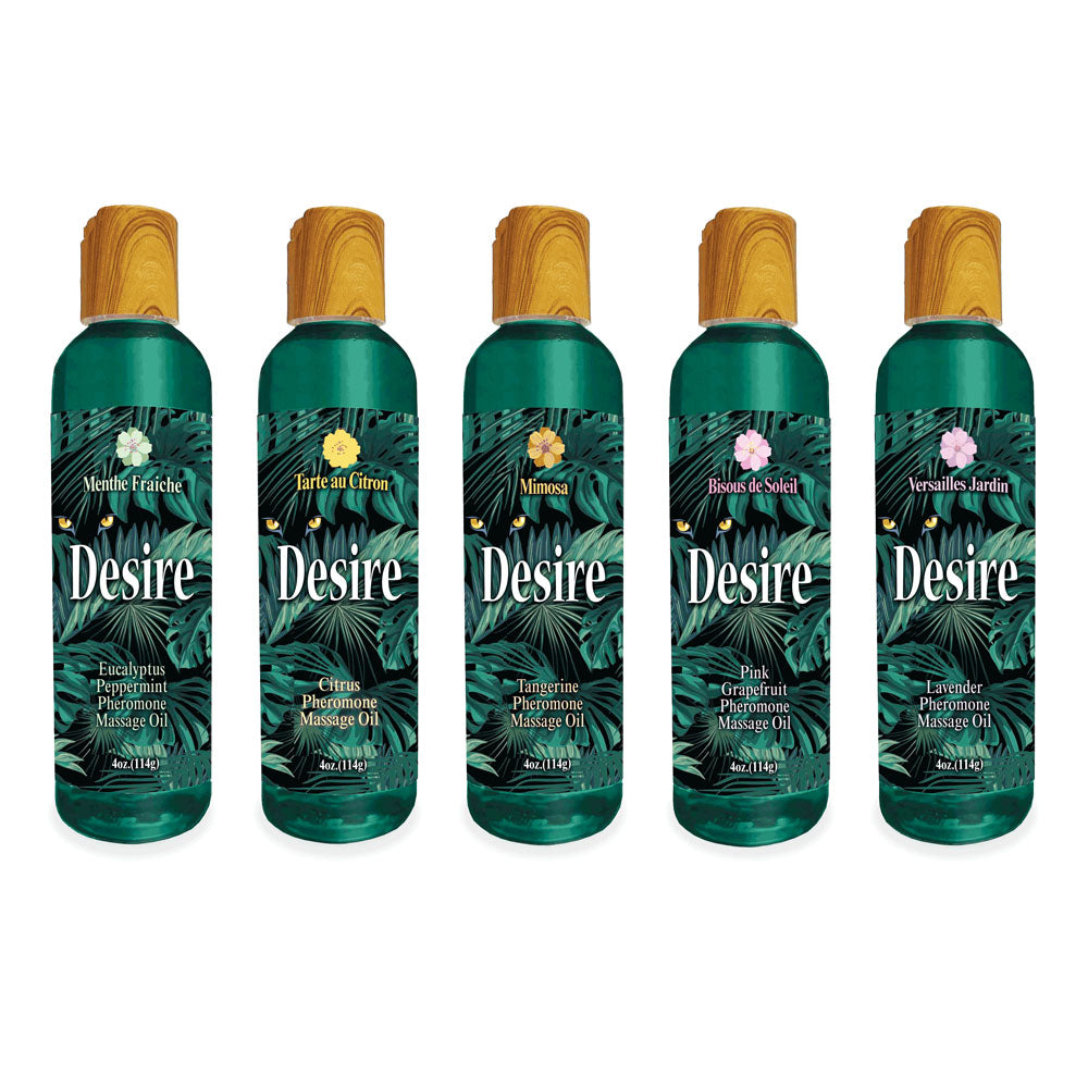 Five bottles of Desire Pheromone Massage Oil, each with a wooden cap, feature scents including Menthe Fraîche, Tarte au Citron, Mimosa, Bious de Soleil, and Versailles Jardin. Pheromone Massage Oil is printed beneath each name.