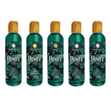 Five bottles of Desire Pheromone Massage Oil, each with a wooden cap, feature scents including Menthe Fraîche, Tarte au Citron, Mimosa, Bious de Soleil, and Versailles Jardin. Pheromone Massage Oil is printed beneath each name.