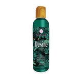 A wooden-capped bottle of Versailles Jardins Desire Pheromone Massage Oil features a lush green tropical leaf design with the label Lavender Scented Pheromone Massage Oil - 118 ml. A delicate flower graphic adorns the brand name at the top.