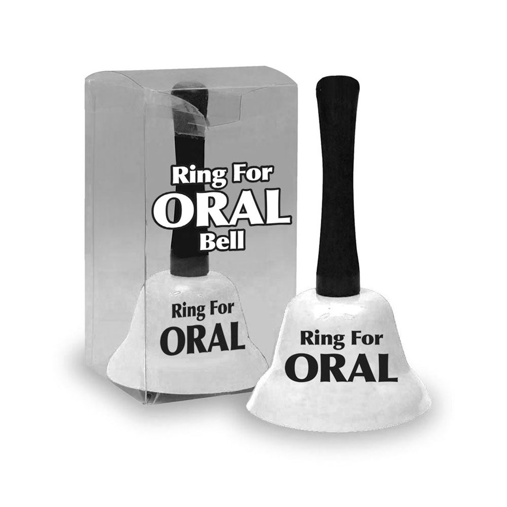 The Ring For Oral Bell, a white novelty hand bell with a black handle and labeled Ring For ORAL, is playfully displayed next to its transparent packaging on a white background, inviting lighthearted fun.