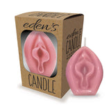 A bold statement piece, Edens Candles Vagina - Vanilla, is a pink, vagina-shaped candle in front of a brown box with a window. The display of 12 vanilla-scented candles labeled edens CANDLE adds perfect ambiance for relaxation.