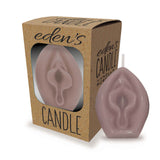 The Edens Candles Vagina is a pale pinkish candle shaped like female genitalia, with a vanilla scent, packaged in a natural brown cardboard box with a clear window. It promises relaxing ambiance and comes in sets of 12 for display.