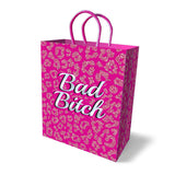 The Bad Bitch Gift Bag - Novelty Gift Bag features a pink leopard print with purple woven handles and bold white text reading Bad Bitch at the center, making it an eye-catching choice for any occasion. Its subtle shadow on the white backdrop enhances its statement-making design.