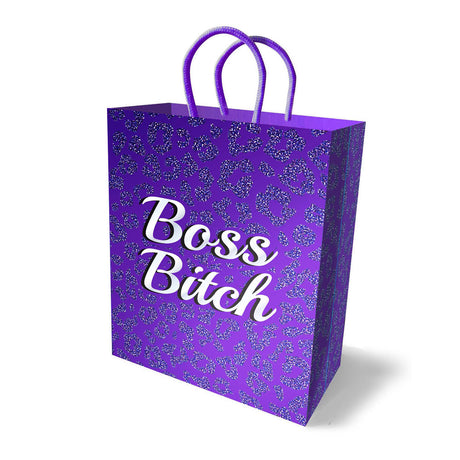 The Boss Bitch Gift Bag - Novelty Gift Bag is made from sturdy card stock, adorned with Boss Bitch in white script on a glittery leopard print. Its purple handles enhance its elegance, adding a stylish shadow effect to the white surface—ideal for gift-giving.