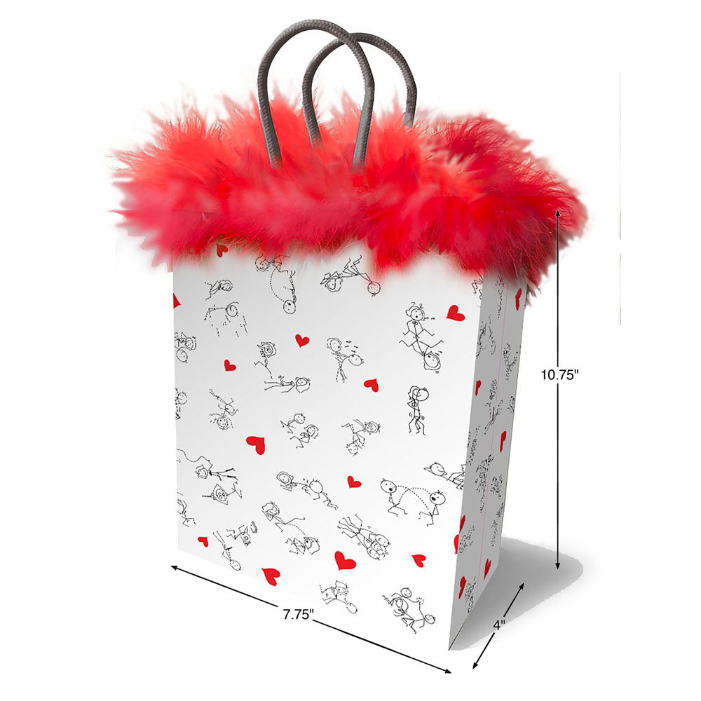 The Naughty Stick Figures Gift Bag is white with playful red hearts and charming black line drawings of dogs and cats. Its 7.75 wide, 10.75 tall, and 4 deep, adorned with a fluffy red trim, and features two gray handles on top for easy carrying.