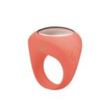 The LAPDANCE Ring Vibe is a pink silicone ring vibrator with a smooth, rounded shape and metallic disc. It has an embossed heart design, a discreet circular button indicating electronic features, and is USB rechargeable, making it perfect for travel.