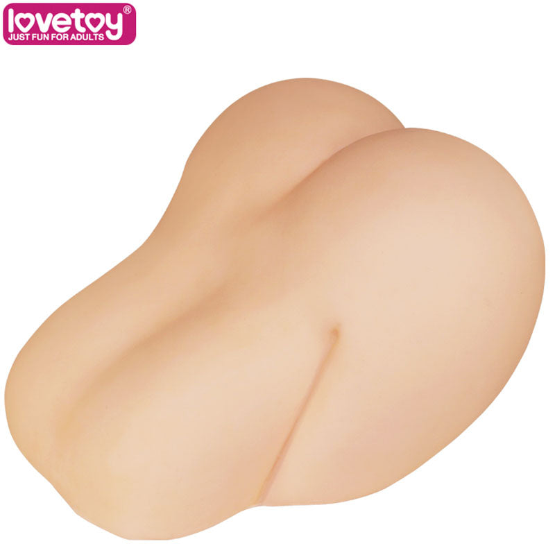 The Feel Me Bare Perfect Pussy & Ass, a phthalate-free TPE mastubator in doggy style, features lifelike buttocks and hips with smooth, skin-toned contours against a white background. A pink lovetoy JUST FUN FOR ADULTS logo sits in the top-left corner, ideal for satisfying solo play.