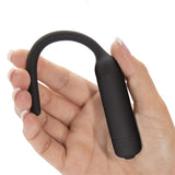 A manicured hand, with light pink nails, holds a sleek black Ultimate Silicone Vibrating Urethral Dilator. Its smooth, curved handle and cylindrical body enhance grip and insertion, emphasizing its minimalist, ergonomic design for prostate stimulation.