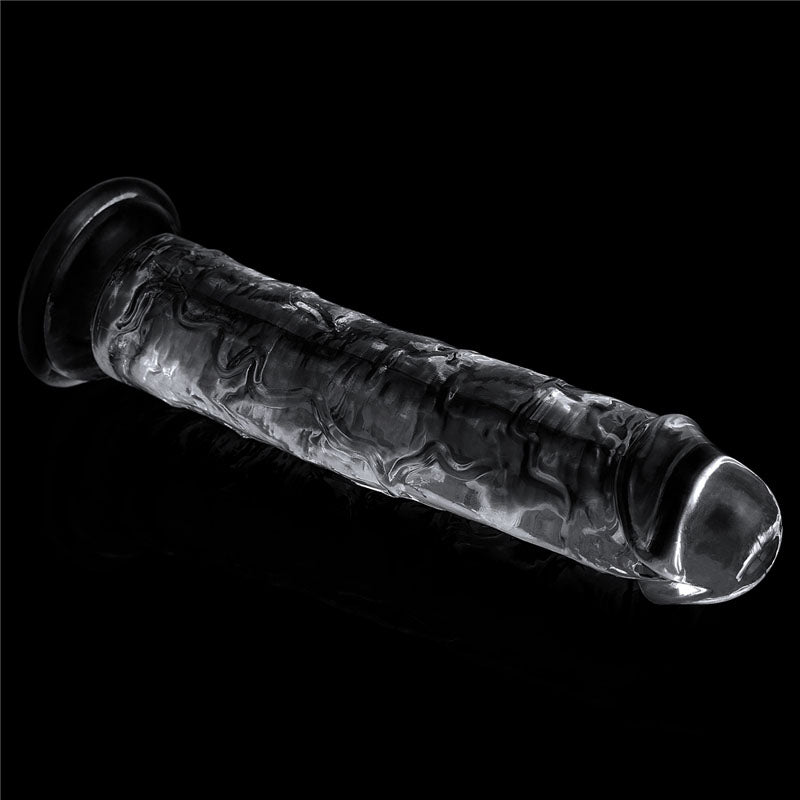 The Flawless Clear Dildo 7 (17.8 cm Dong) is a transparent glass sculpture featuring a cylindrical rod with a rounded dome-like end and a flared suction cup base. It has intricate, swirling textures and patterns that stand out against the black background, emphasizing its clarity and reflectivity.