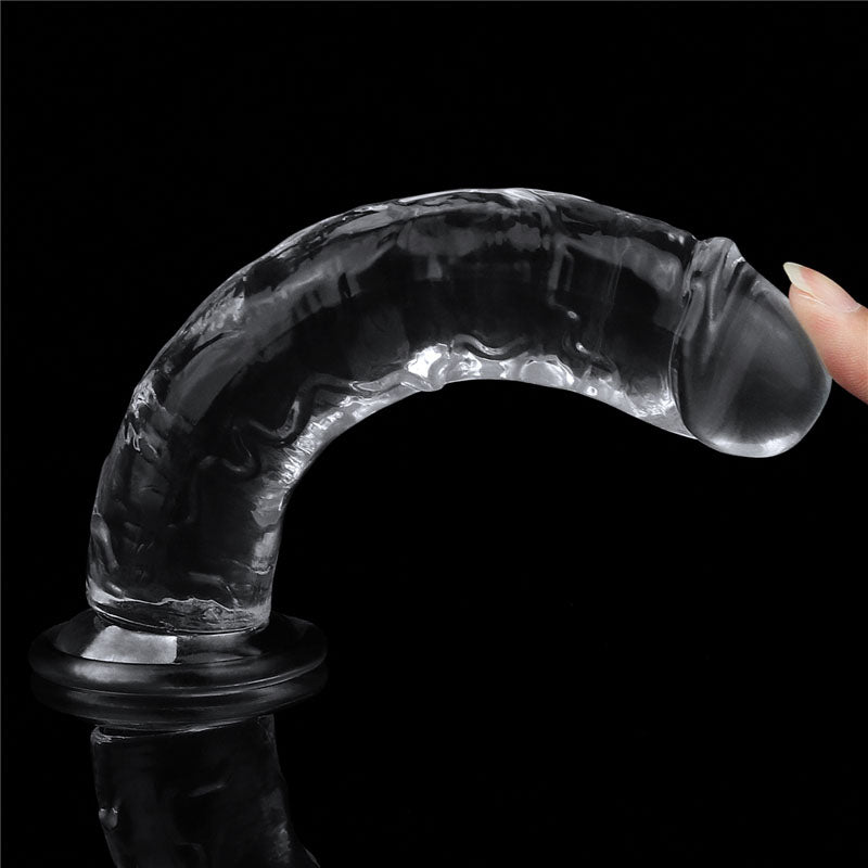 Part of the Clear Series, the Flawless Dildo 7 – 17.8 cm Dong is a transparent, curved glass sculpture with a textured surface on a black base. A finger grazes its lifelike edge, highlighting its details, while its glossy finish beautifully reflects light against a dark background.