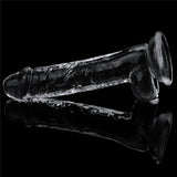 The Flawless Clear Dildo 7.5, part of the LOVETOY shameless clear series, is a skin-safe transparent 19 cm dong with a phallic shape. It rests horizontally against a black background, featuring a smooth texture, slight curve, and suction cup base for stability, with reflections enhancing its intricate details.