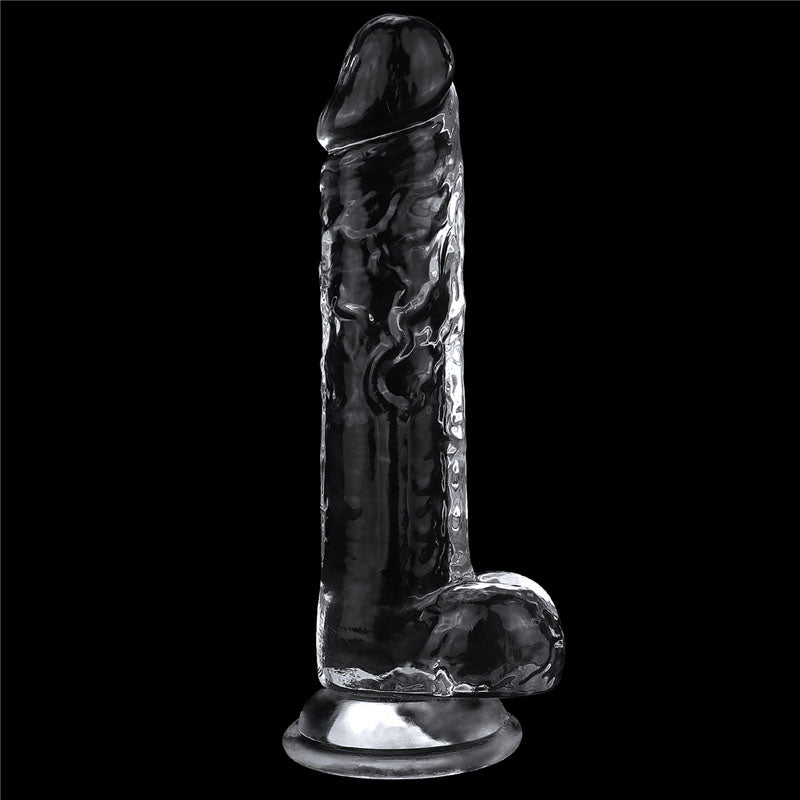 The Flawless Clear Dildo 7.5 - Clear 19 cm Dong is a glass-like sculpture with an anatomical male phallus shape. It stands upright on a black background, featuring a smooth, textured surface and a suction cup base for freestanding support as part of the Shameless Clear Series.