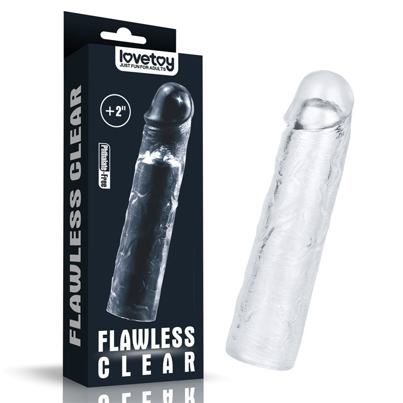 A clear, textured Flawless Clear Penis Sleeve 2 crafted from skin-safe TPE is shown beside its black packaging with Flawless Clear and Lovetoy branding, offering a +2 length increase.